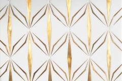 Èze, a waterjet cut stone mosaic, shown in polished Thassos and brushed brass, was designed by Caroline Beaupère for New Ravenna.
