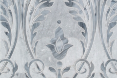 Monaco Floral, a waterjet cut stone mosaic, shown in honed Bardiglio light and polished Greystoke, is a design by Caroline Beaupère for New Ravenna.