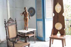 In Nelson Domínguez’s historic Old Havana studio, Victorian pieces are in dialogue with his clothespin-backed throne—behind is a balcony overlooking the extensive rear garden.