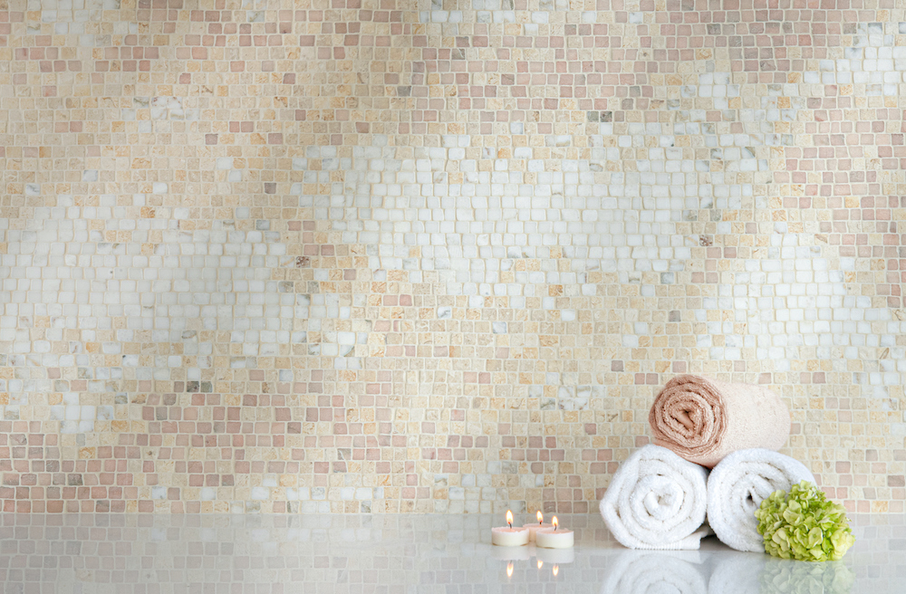 Mist Dawn, a hand-chopped stone mosaic, shown in tumbled Calacatta Monet, Travertine White, Jerusalem Gold, and Rosa Portogallo, is part of the Heritage Collection by New Ravenna.