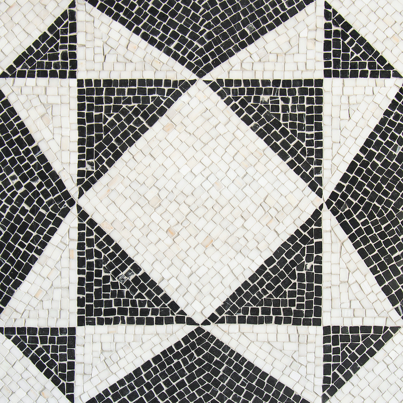 Palatium, a hand-chopped stone mosaic, shown in tumbled Calacatta Monet and Nero Marquina, is part of the Heritage Collection by New Ravenna.