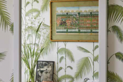 f ever we feel homesick for the tropics, we stand in this bathroom and breathe in the view of the palm fronds. The bookstand trolley was from Kensington Place and has KP carved on the underside to prove it. My mother’s grandmother (the granddaughter of Queen Victoria) had apartments there when she was widowed. Spot the photograph of Prince Charles at his Investiture, aged twenty; this is when he became the Prince of Wales.