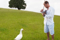 Playing violin to a duck