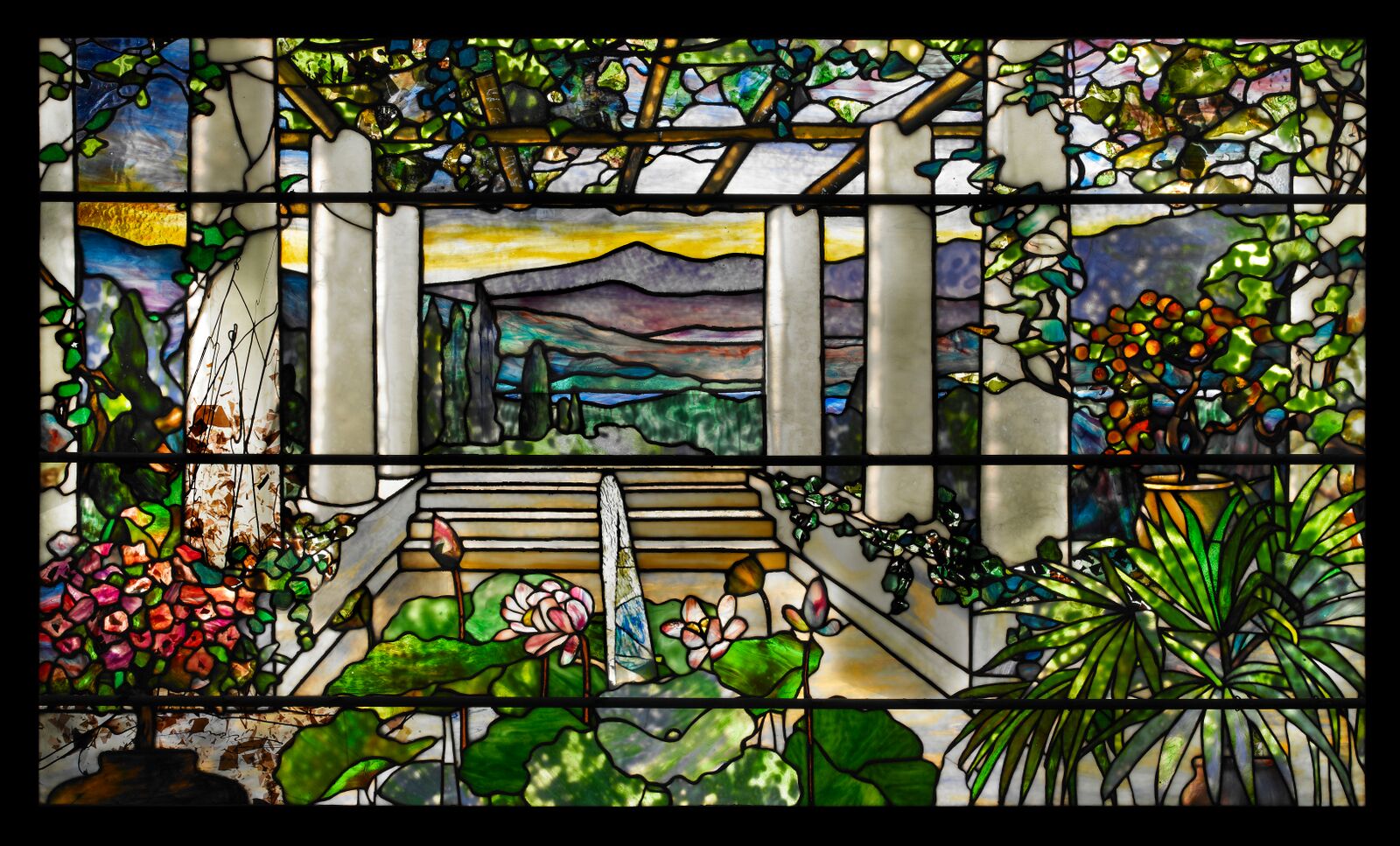 Tiffany Studios, Garden Landscape Window , 1900–1910, leaded glass. Photograph by John Faier. © 2013 Driehaus Museum