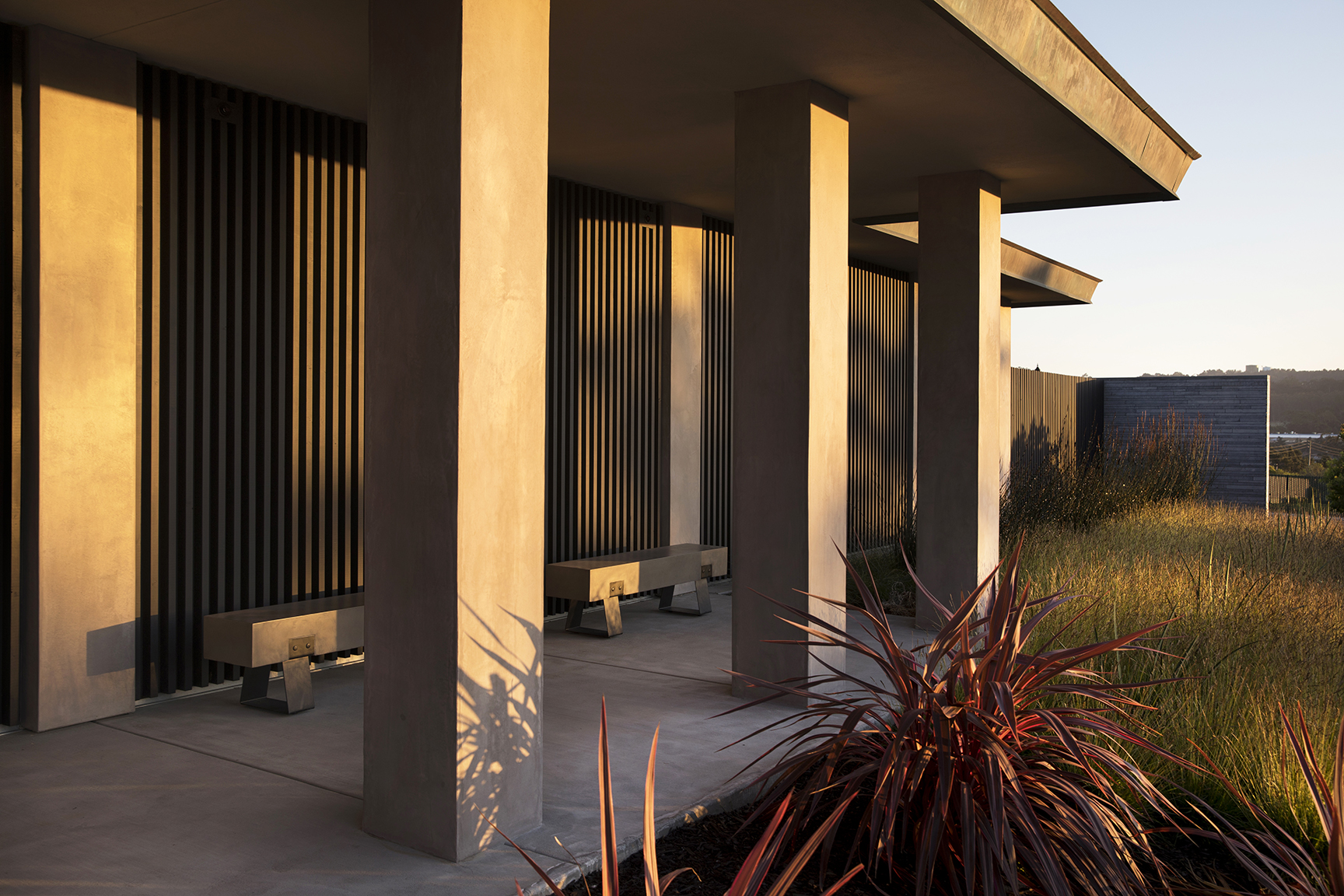 The walls and columns of the original 1960s structure, a midcentury modern, had been clad in aggregate stone.