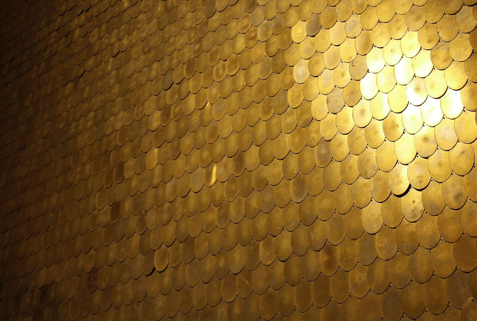 The result? Oval-shaped, hand-hammered brass tiles that can be arranged and overlaid in patterns for walls in offices, restaurants or homes.
