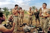 April 15, 2003 United States Marines take a break to shave in front of one of Saddam Hussain\'s presidential palaces the day Tikrit fell from Republican Guard rule in Iraq. (Credit: Lynsey Addario/ VII)